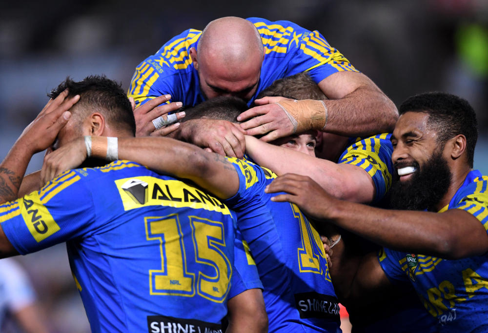 William Smith (centre) of the Eels is congratulated after scoring a try