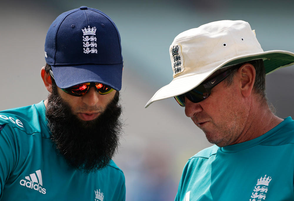 England's Moeen Ali, left, talks to coach Trevor Bayliss during a practice session a day ahead of their final match of the ICC World Twenty20 2016 cricket against West Indies, in Kolkata, India, Saturday, April 2, 2016.