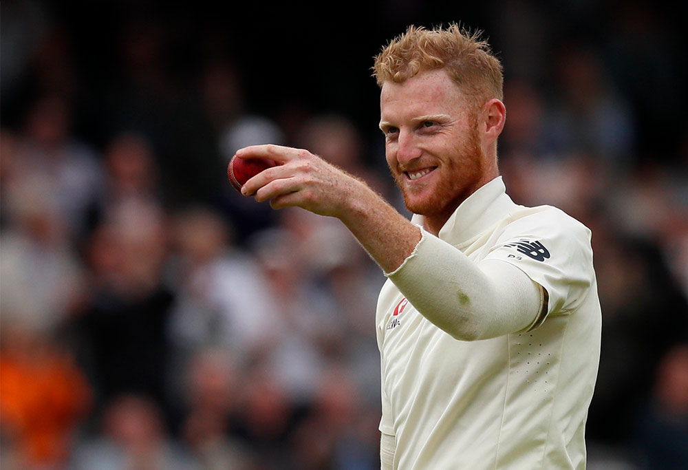 Ben Stokes holds up the ball and grins after taking his sixth wicket