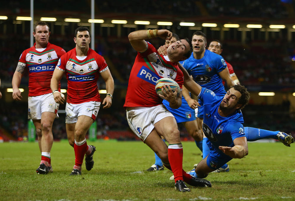 Matt Seamark of Wales is tackled by Joshua Mantellato (R) of Italy during the Rugby League World Cup Inter group match between Wales and Italy at the Millennium Stadium on October 26, 2013 in Cardiff, Wales.