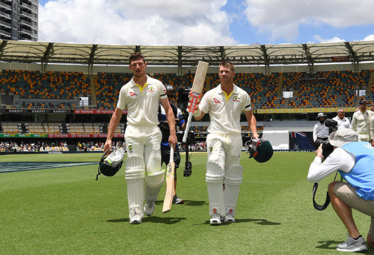 Australian batsmen David Warner (right) and Cameron Bancroft walk from the field after Australia won on Day 5 of the First Test match between Australia and England at the Gabba in Brisbane, Monday, November 27, 2017.