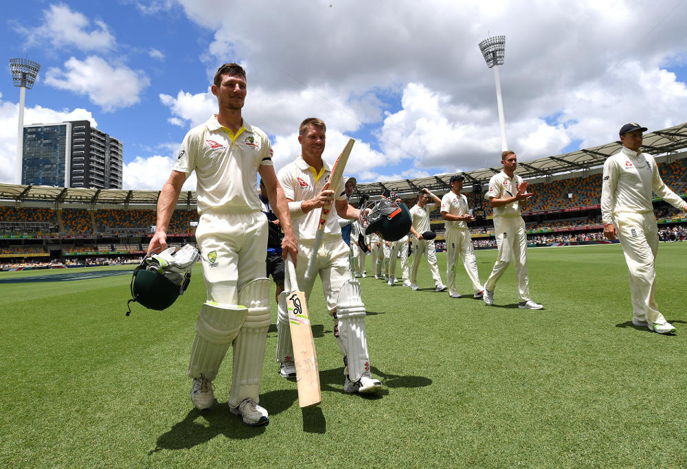 Australian batsmen David Warner and Cameron Bancroft (left) walk from the field after Australia won on Day 5 of the First Test match between Australia and England at the Gabba in Brisbane, Monday, November 27, 2017.