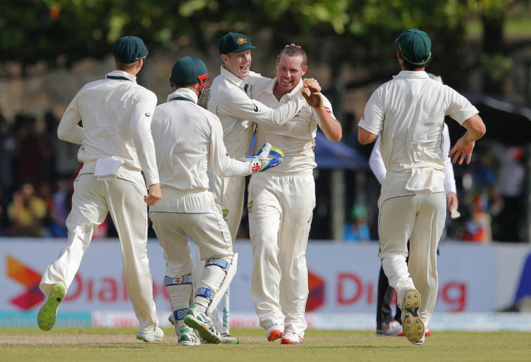 Jon Holland celebrates a wicket for Australia