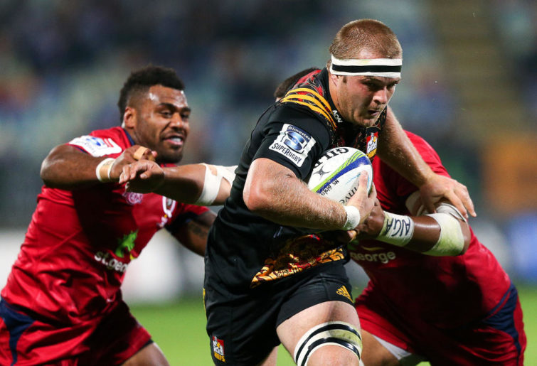 Sam Cane of the Chiefs breaks the Reds defence