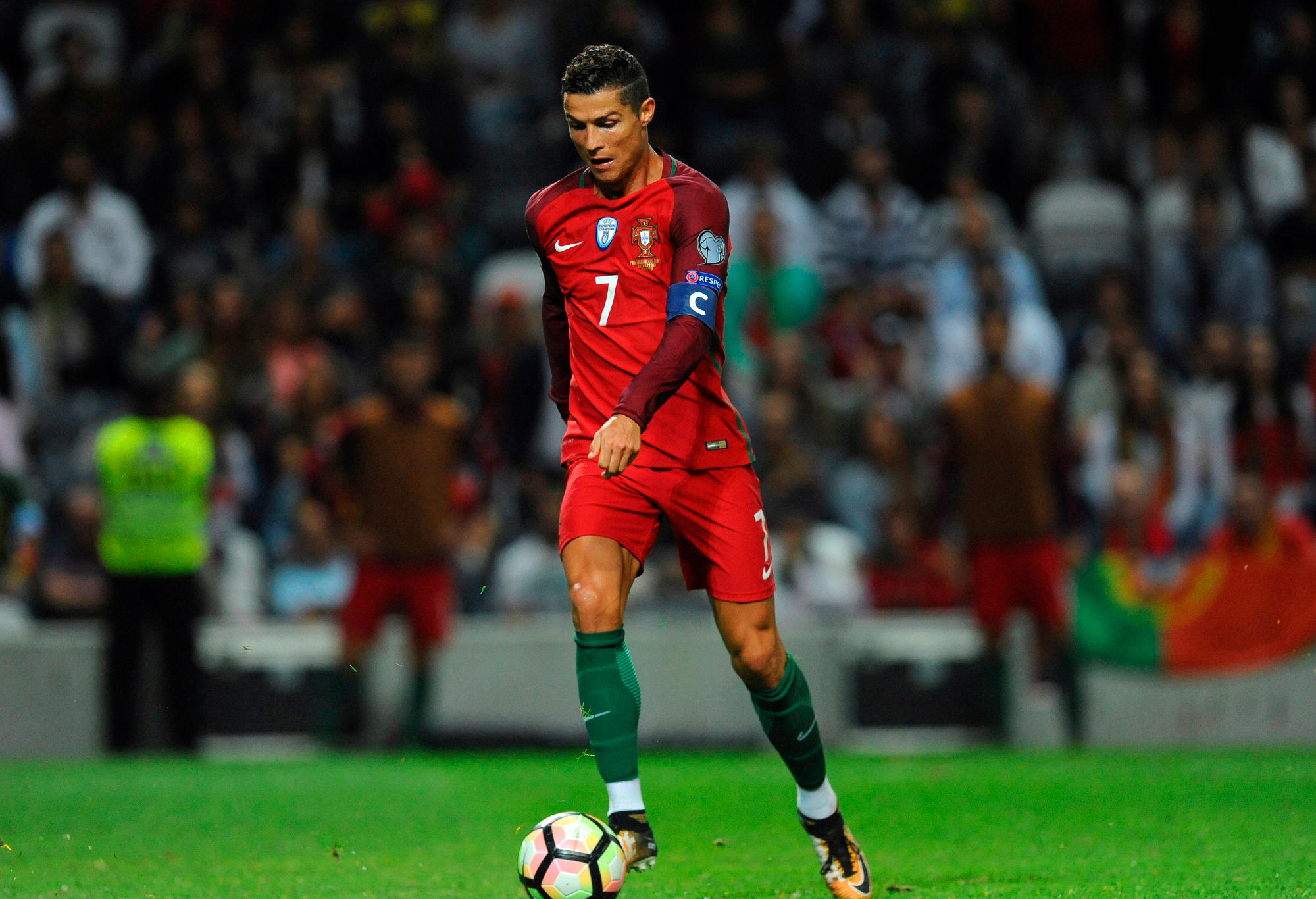 Portugal's Cristiano Ronaldo scores his side's fourth goal during the World Cup Group B qualifying soccer match between Portugal and Faroe Islands at the Bessa Stadium in Porto, Portugal.