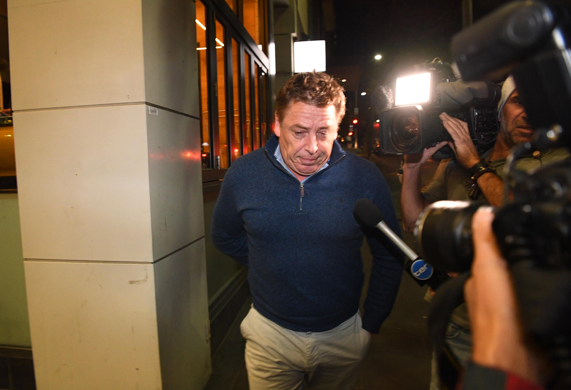 Mark Thompson is seen exiting the Melbourne Magistrates Court.