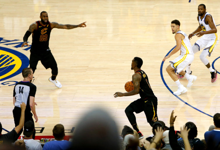 OAKLAND, CA - MAY 31: JR Smith #5 of the Cleveland Cavaliers dribbles in the closing seconds of regulation as LeBron James #23 attempts direct the offense against the Golden State Warriors in Game 1 of the 2018 NBA Finals at ORACLE Arena on May 31, 2018 in Oakland, California. NOTE TO USER: User expressly acknowledges and agrees that, by downloading and or using this photograph, User is consenting to the terms and conditions of the Getty Images License Agreement.