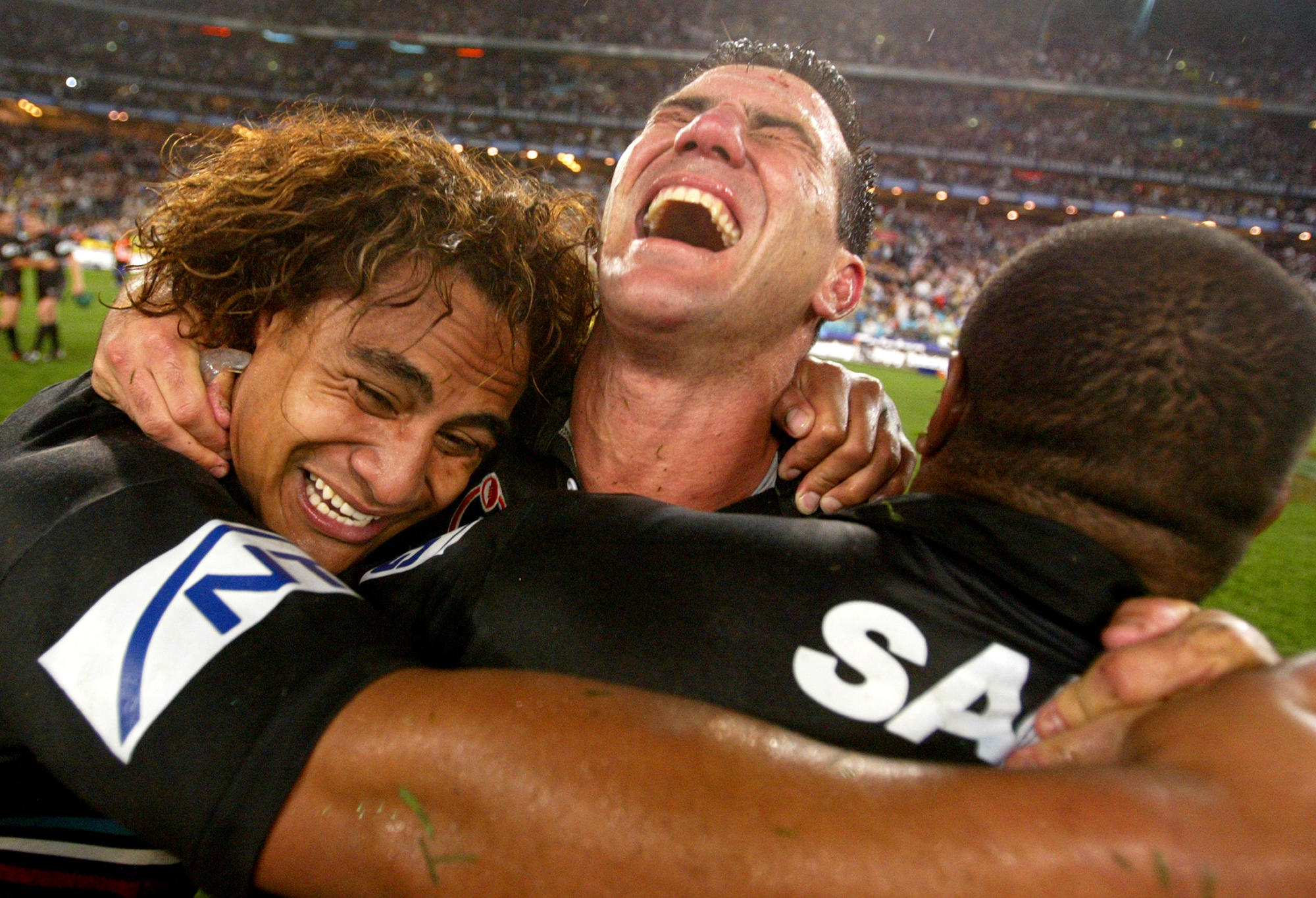Joe Galuvao #11, Scott Sattler #13 and Rhys Wesser #1 of the Panthers celebrate victory during the NRL Grand Final between the Sydney Roosters and the Penrith Panthers at Telstra Stadium October 5, 2003 in Sydney, Australia. Penrith won 18-6.