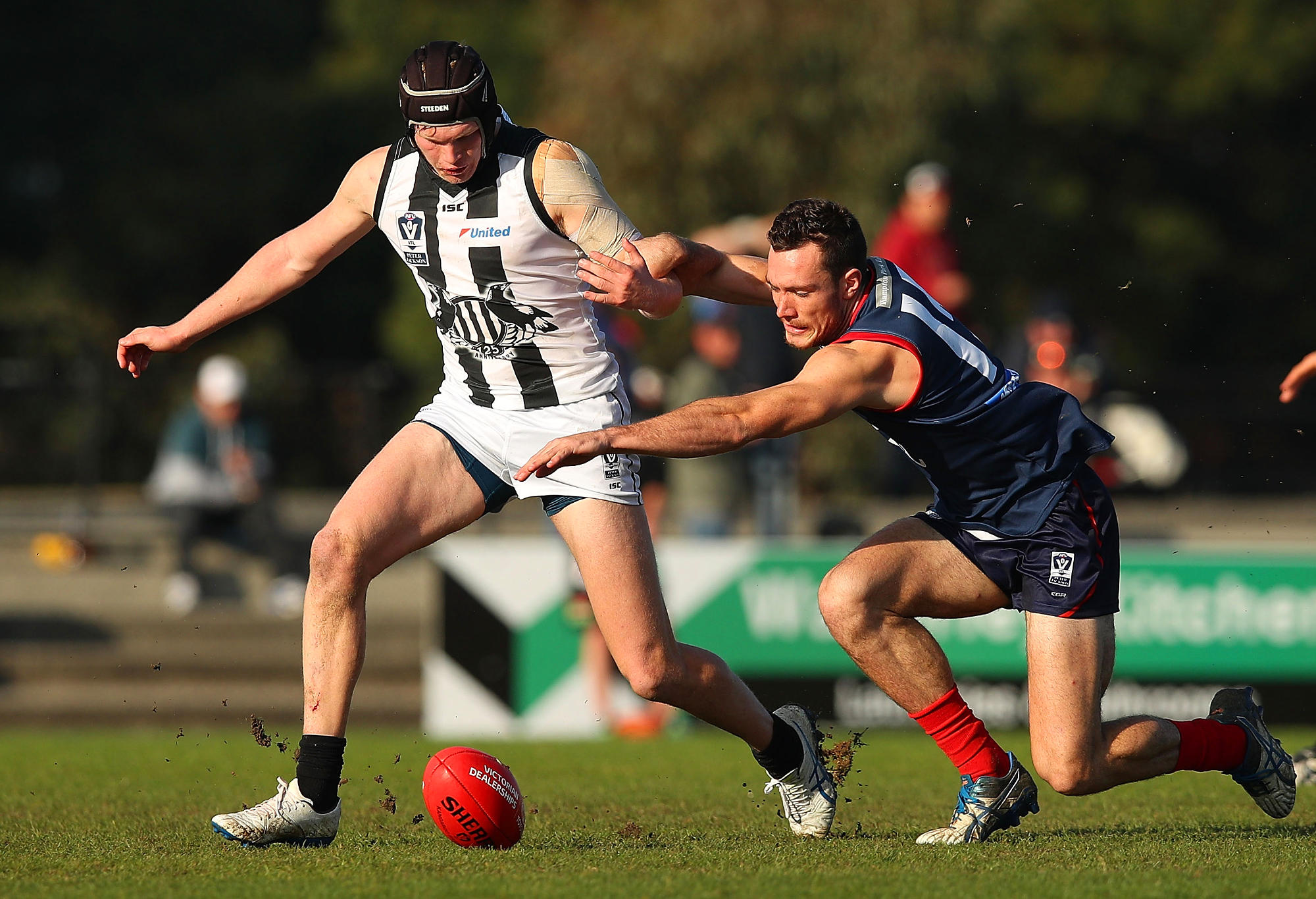 Sam Mclarty of Collingwood (L) chases the ball during the round eight VFL match between Casey Demons and Collingwood Magpies at Casey Fields on June 10, 2017 in Melbourne, Australia.