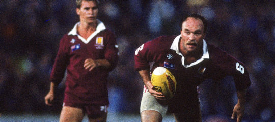 Wally Lewis brings the ball up for Queensland.