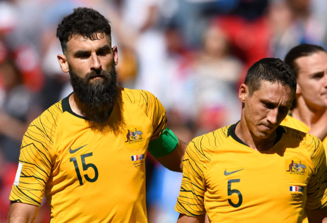 Socceroos Mile Jedinak and Mark Milligan react after losing a World Cup game