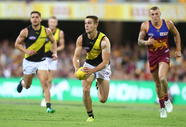 Jayden Short of the Tigers runs the ball during the round four AFL match between the Brisbane Lions and the Richmond Tigers in Brisbane, Australia.