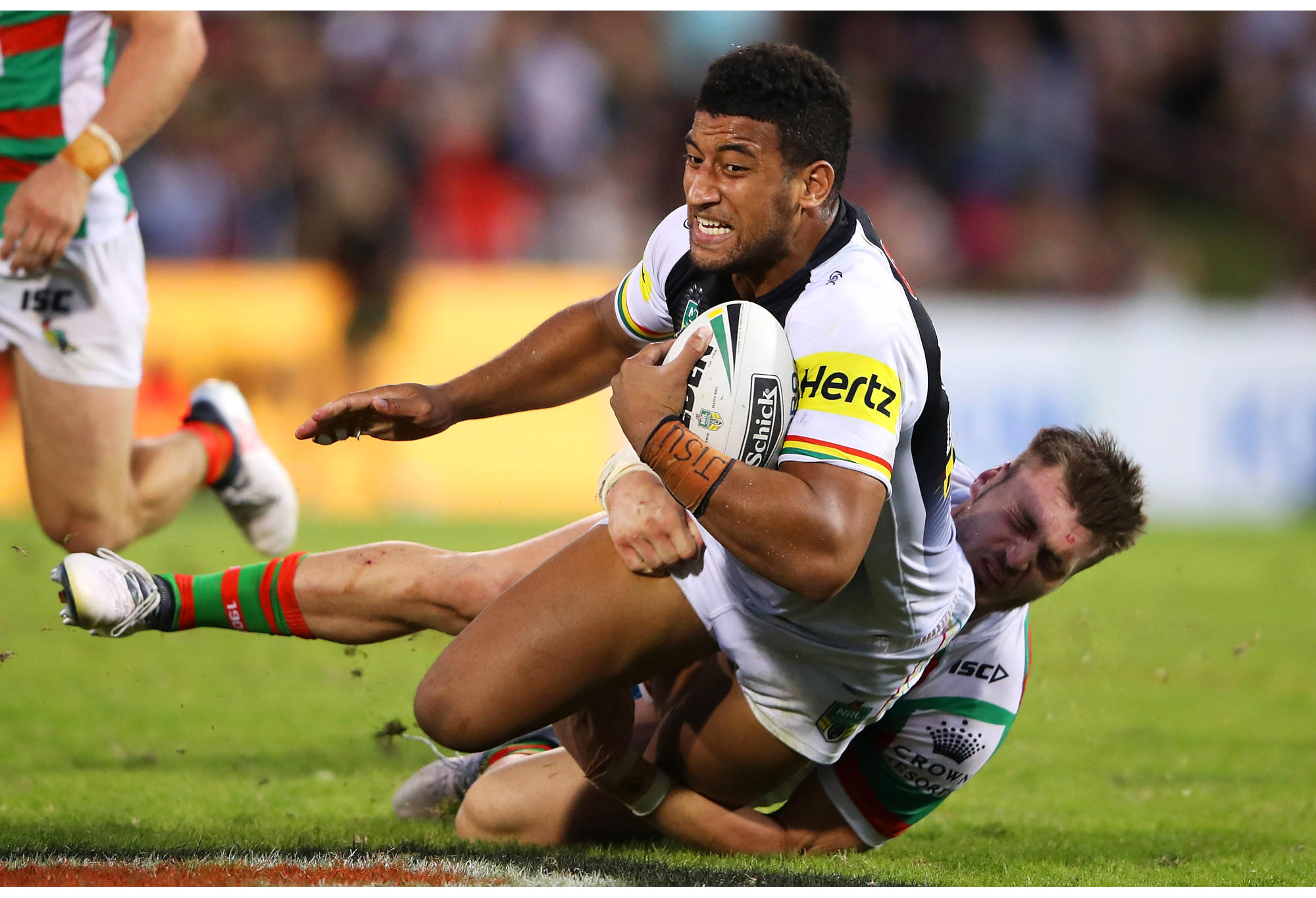 Viliame Kikau of the Panthers is tackled during match against Rabbitohs.