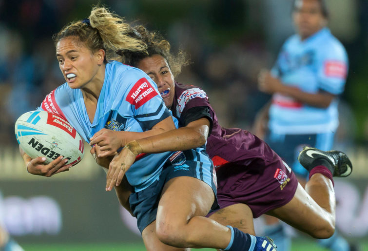 Tallisha Harden of the Maroons tackles Nita Maynard of the Blues during the Women's State of Origin match.