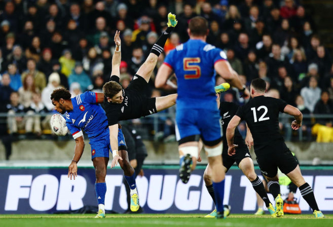 Benjamin Fall of France tackles Beauden Barrett of the All Blacks in the air