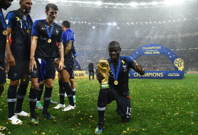 France's midfielder N'Golo Kante poses with the World Cup trophy