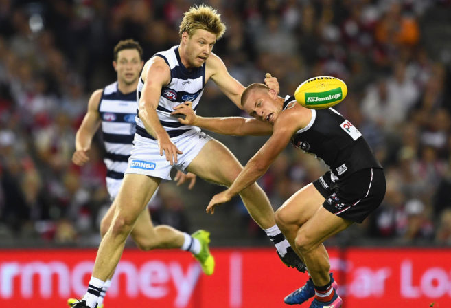 George Horlin-Smith competes for the ball with Seb Ross during an AFL match.