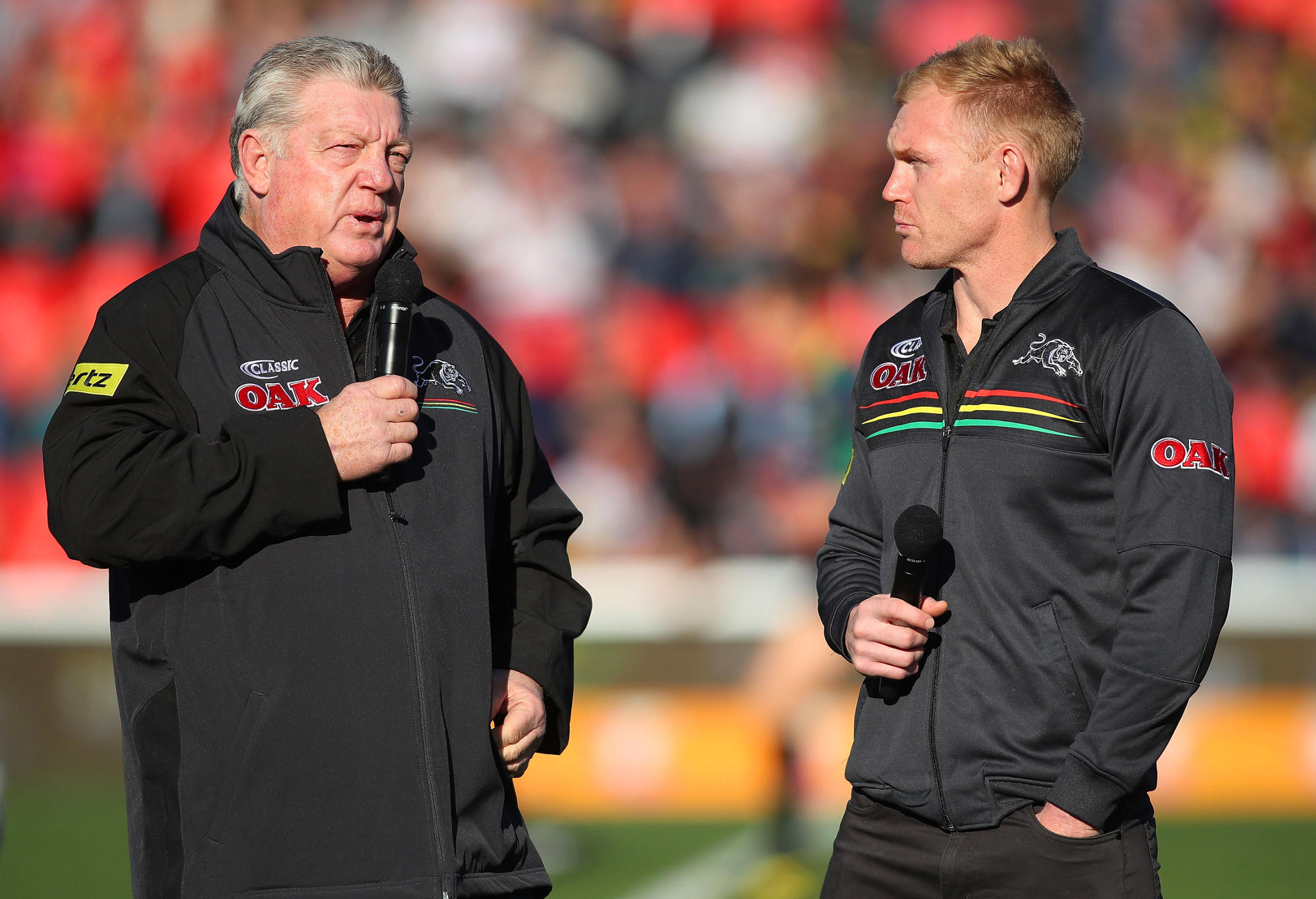 Phil Gould talks with Peter Wallace on the field.