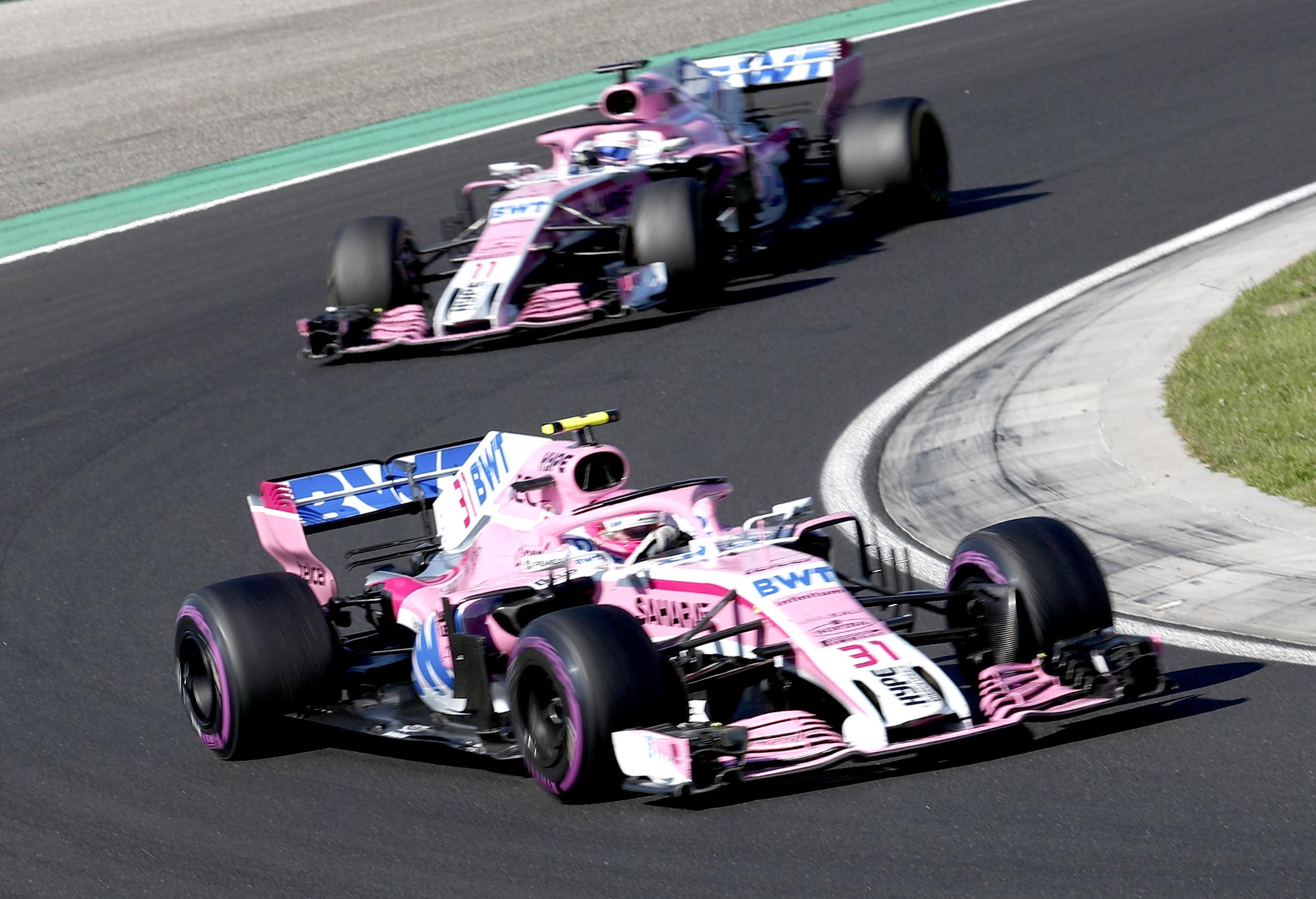 Force India driver Esteban Ocon of France takes a curve followed by teammate Sergio Perez of Mexico during the Hungarian Formula One Grand Prix, at the Hungaroring racetrack in Mogyorod, northeast of Budapest, Sunday, July 29, 2018. (AP Photo/Laszlo Balogh)