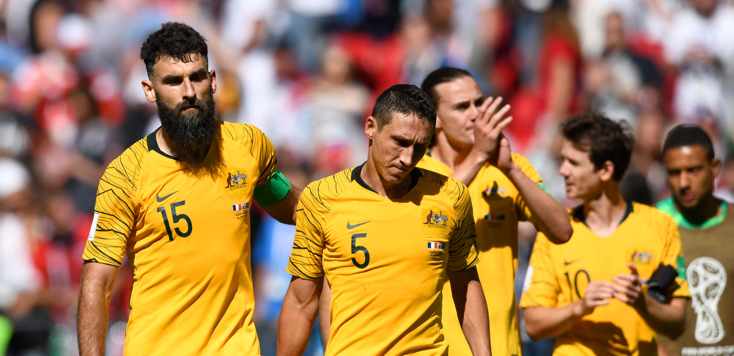 Mark Milligan and Mile Jedinak react after the Scceroos' loss to France