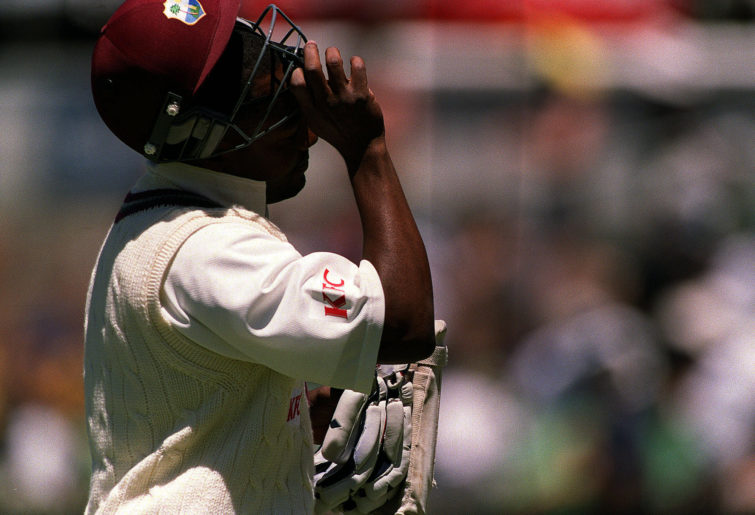 Brian Lara walks off the field, dejected, after being dismissed first ball by Glenn McGrath.