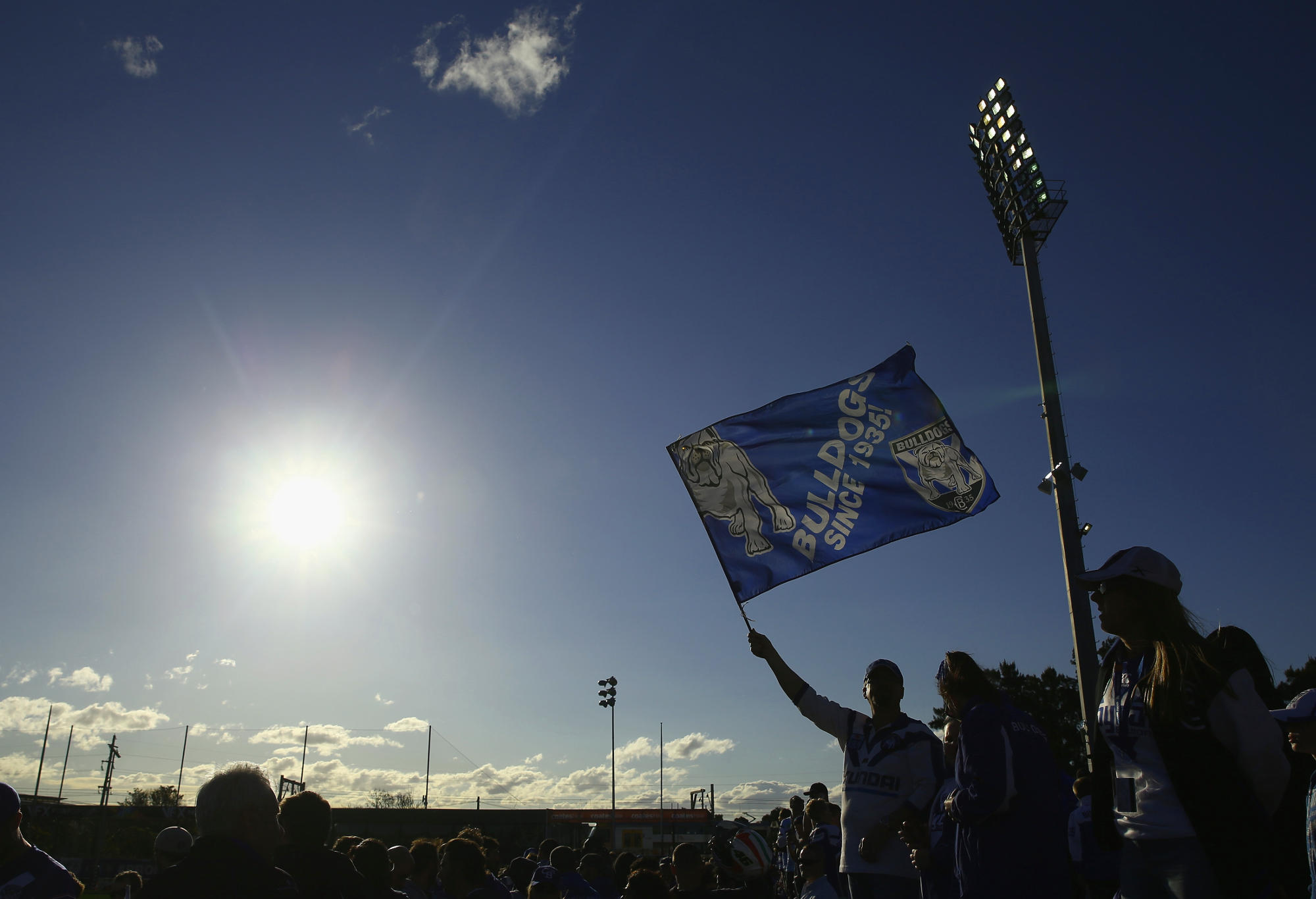 A Bulldogs fan waves a flag at a match in Belmore