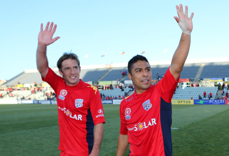 Jeronimo Neumann (L) and Cassio (R) of Adelaide celebrate