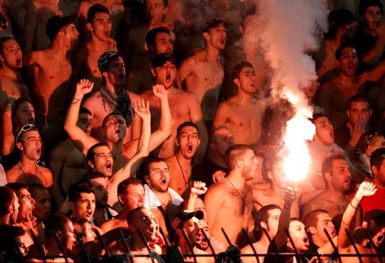 Greek football fans let off a flare