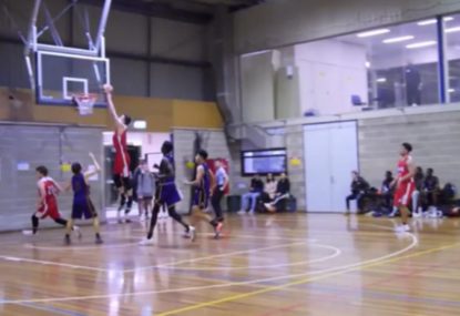 Young basketballer jams perfectly nonchalant dunk