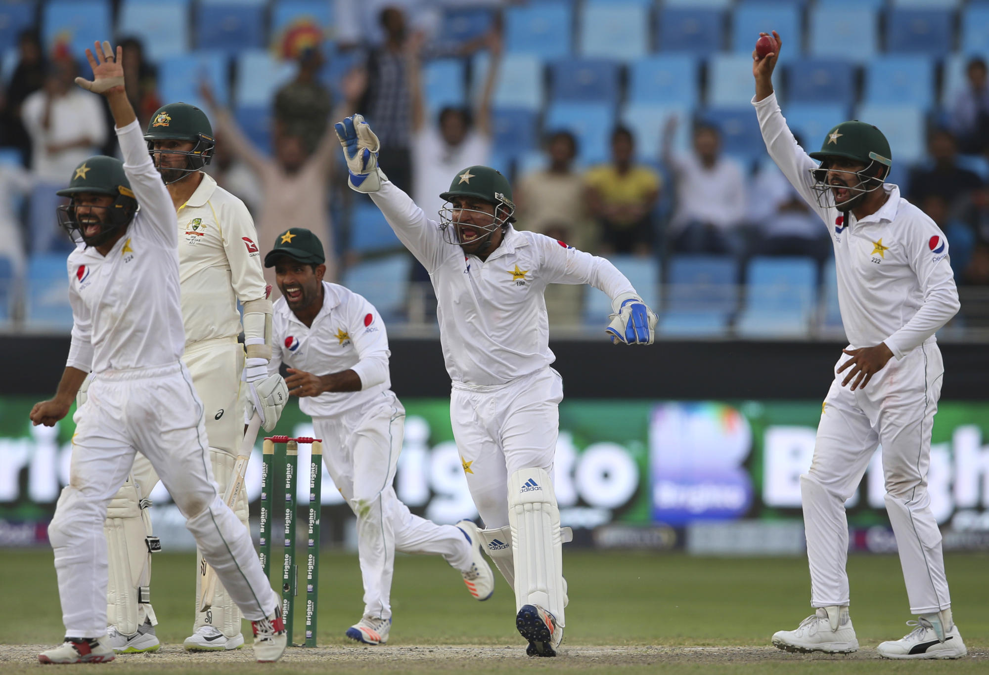 Pakistan wicketkeeper Sarfraz Ahmed appeals a wicket against Australia's Nathan Lyon with teammates