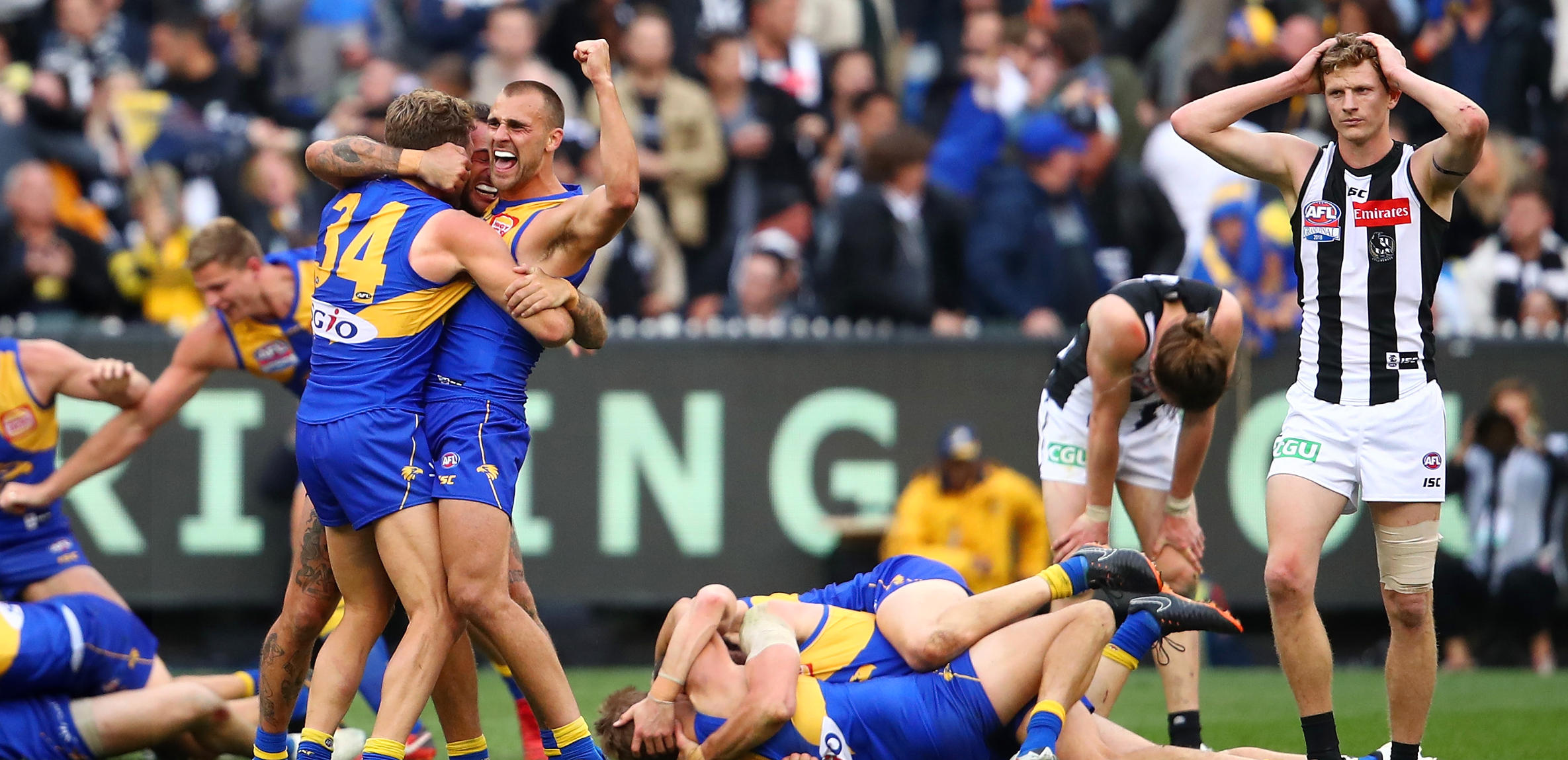 Dom Sheed and teammates celebrate winning the 2018 AFL Grand Final