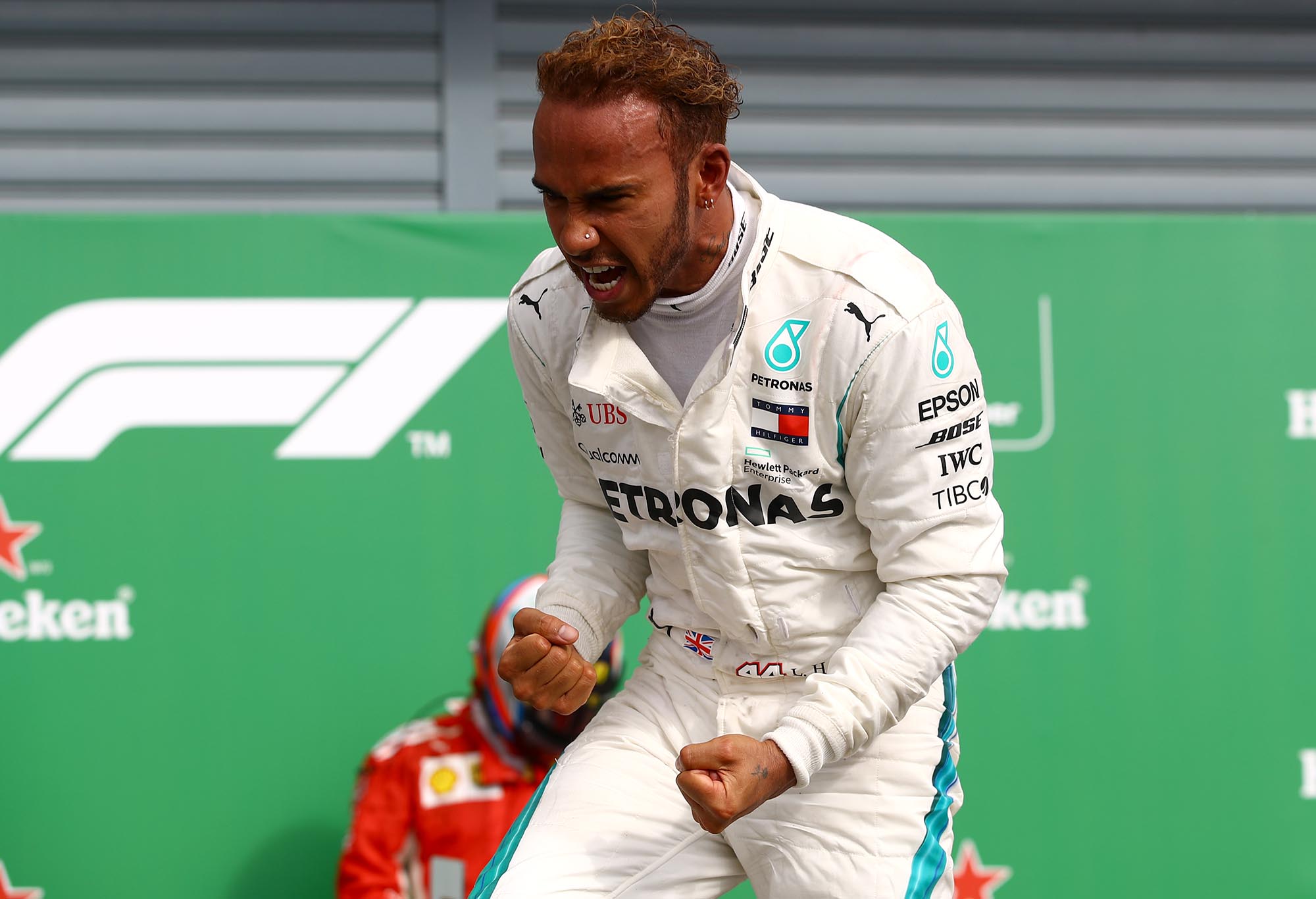 Lewis Hamilton stands atop his Mercedes after winning the Italian Grand Prix.