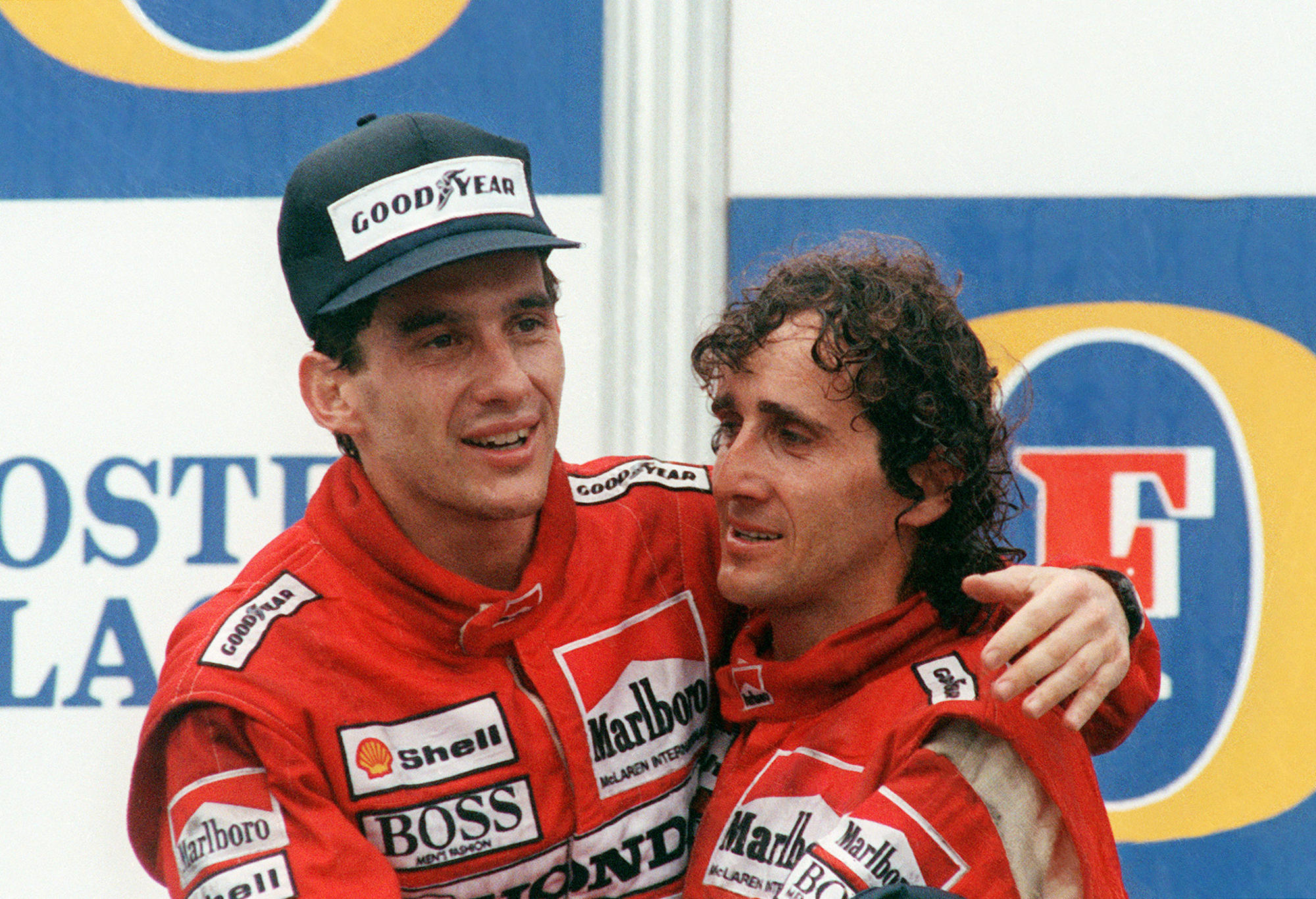 Two formula one drivers on the podium