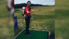 Legend dad doesn't let baby stop him from hitting the driving range