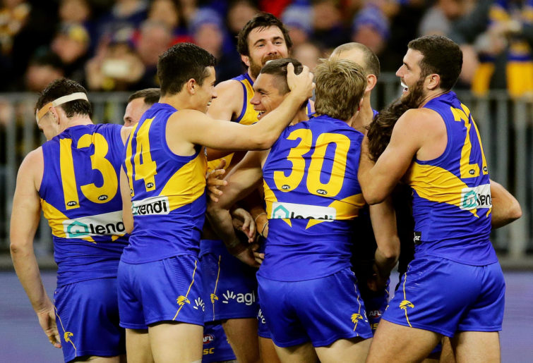 Jarrod Cameron of the Eagles is mobbed by team mates