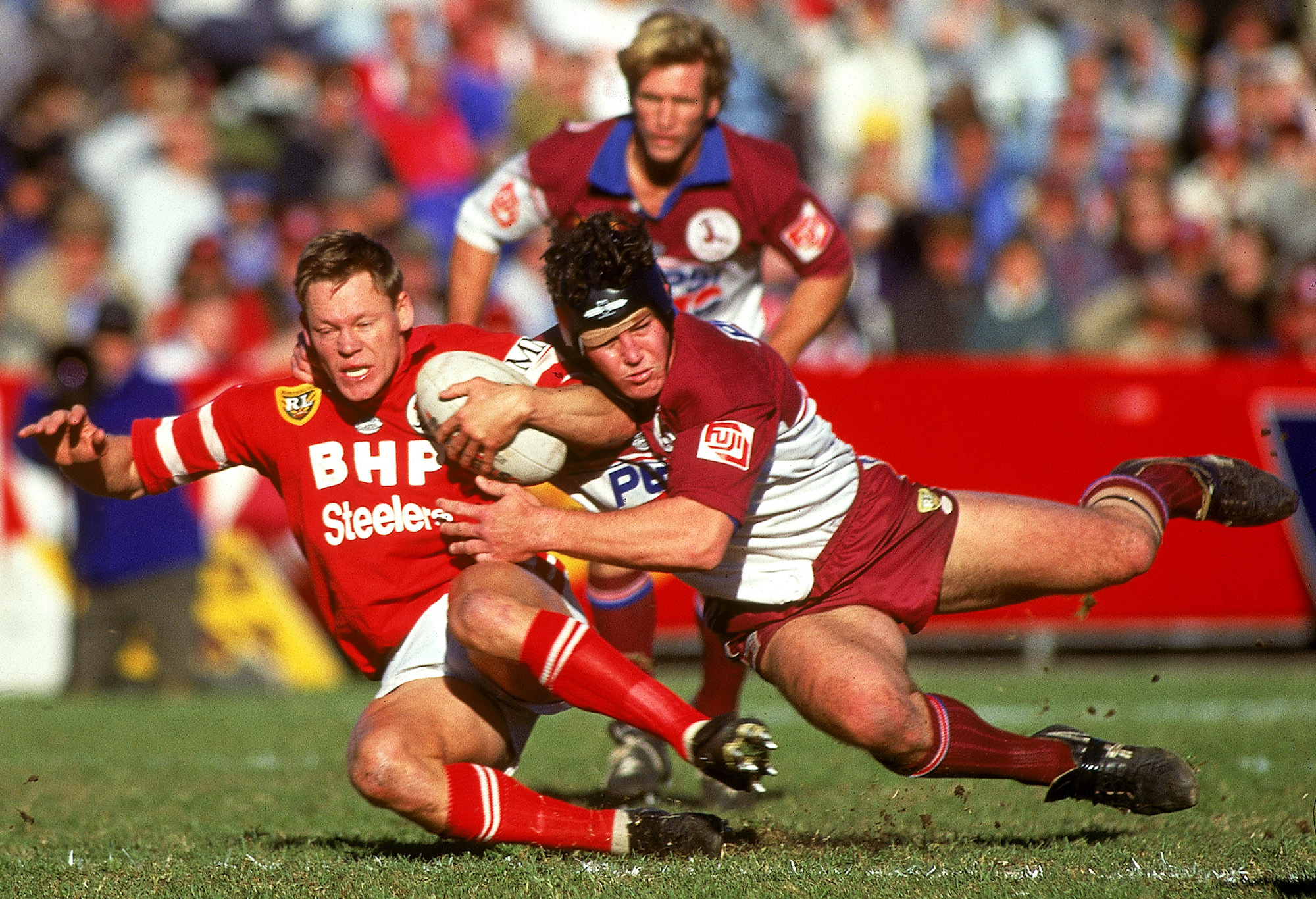 Illawarra’s Rod Wishart brought down by Manly’s Mark Carroll.