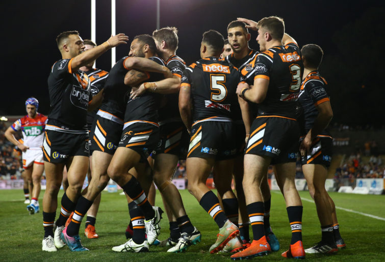 The Tigers celebrate a try.