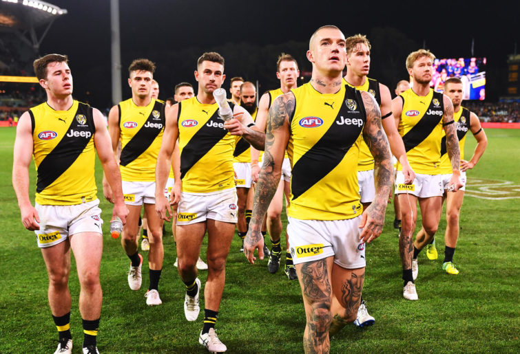 Dustin Martin leads the Tigers off after a loss
