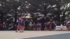 Netball player blocks shot by standing on teammate