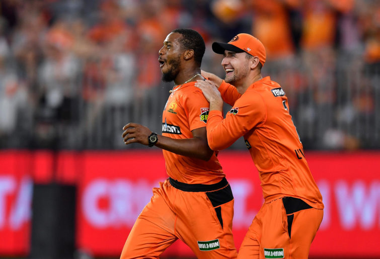 Chris Jordan of the Scorchers is congratulated by Liam Livingstone after taking a catch