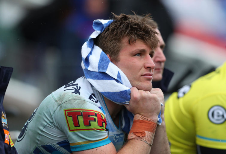 Jai Arrow of the Gold Coast Titans sits on the bench