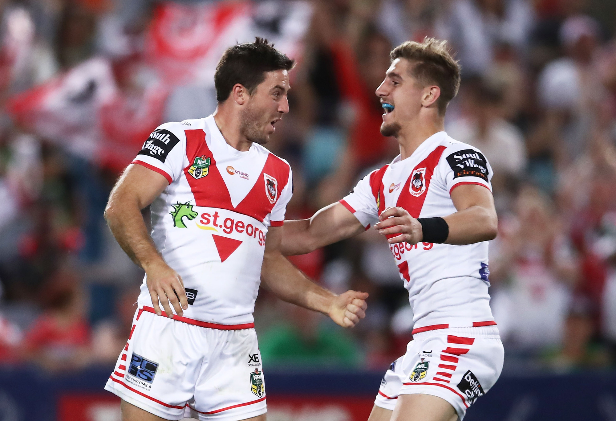Ben Hunt (L) of the Dragons celebrates with Zac Lomax (R) after scoring a try