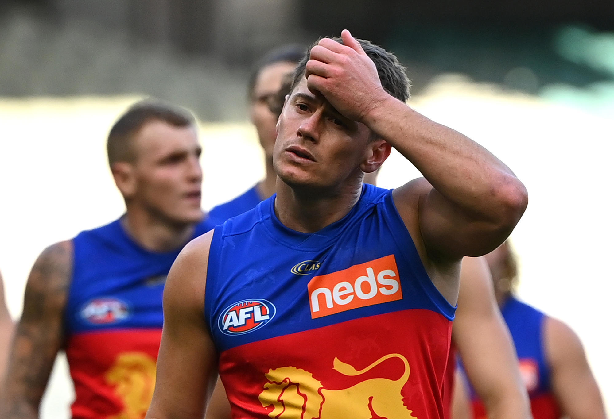 Dayne Zorko and his Lions team mates look dejected after losing
