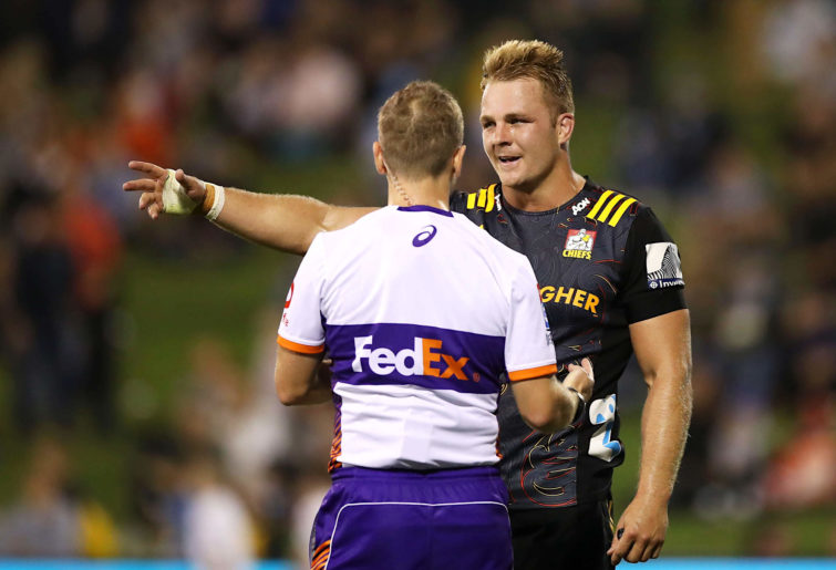 Sam Cane speaks to the referee