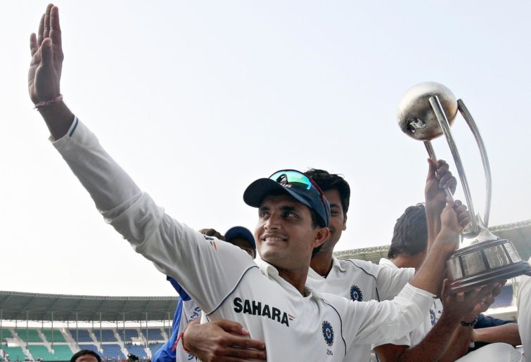 Sourav Ganguly holds the trophy aloft and waves to the crowd