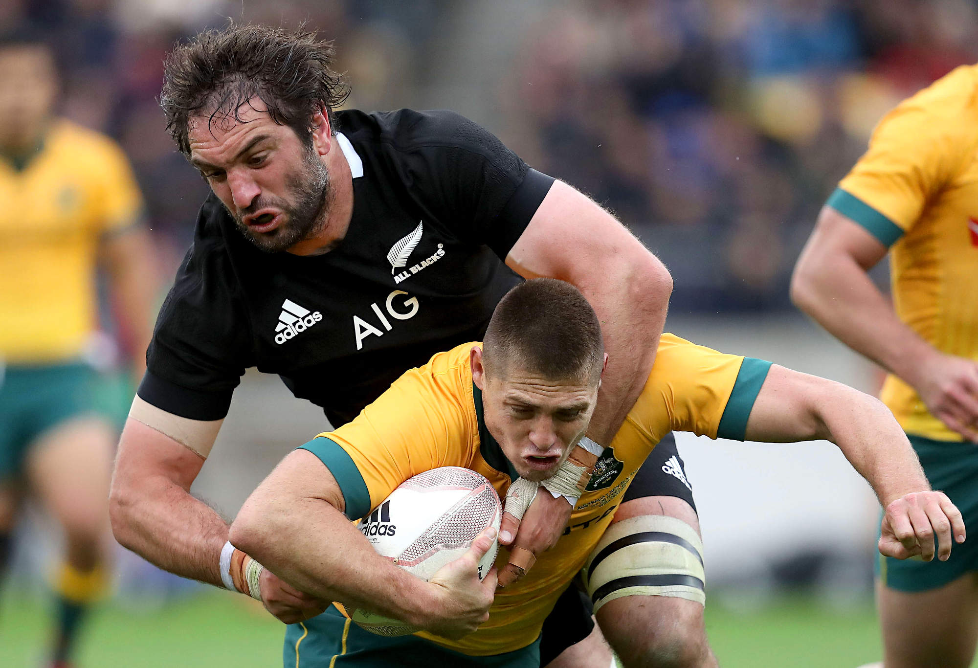 Samuel Whitelock of the All Blacks tackles James O'Connor of the Wallabies