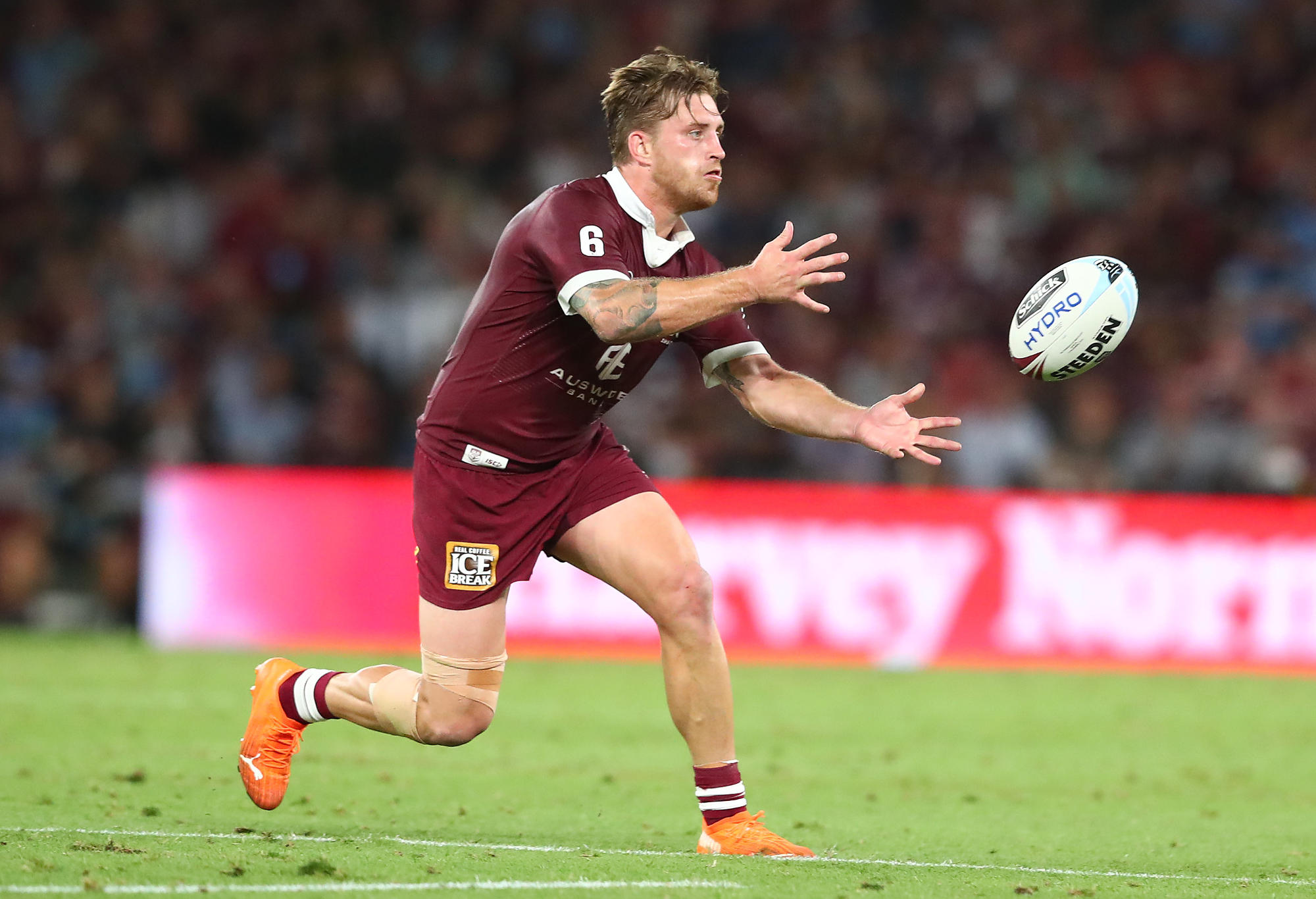 Cameron Munster of the Maroons passes