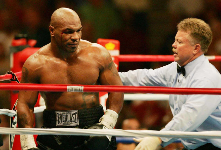 Mike Tyson stands dazed in the middle of the ring