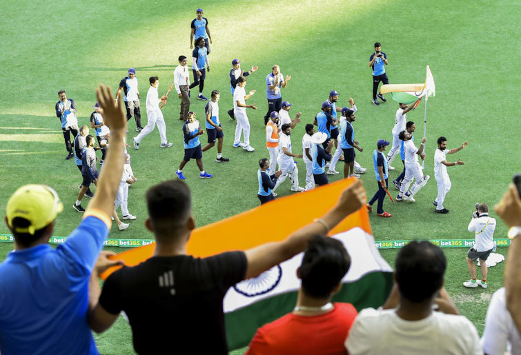 Indian fans celebrate their side's famous day five win in the fourth Test against Australia at the Gabba, Brisbane
