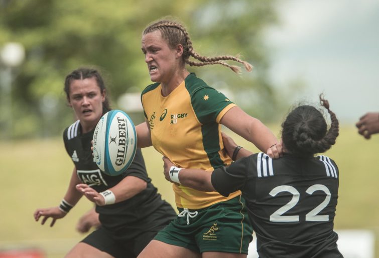 Arabella McKenzie breaks the tackle of New Zealand's Amanda Rash